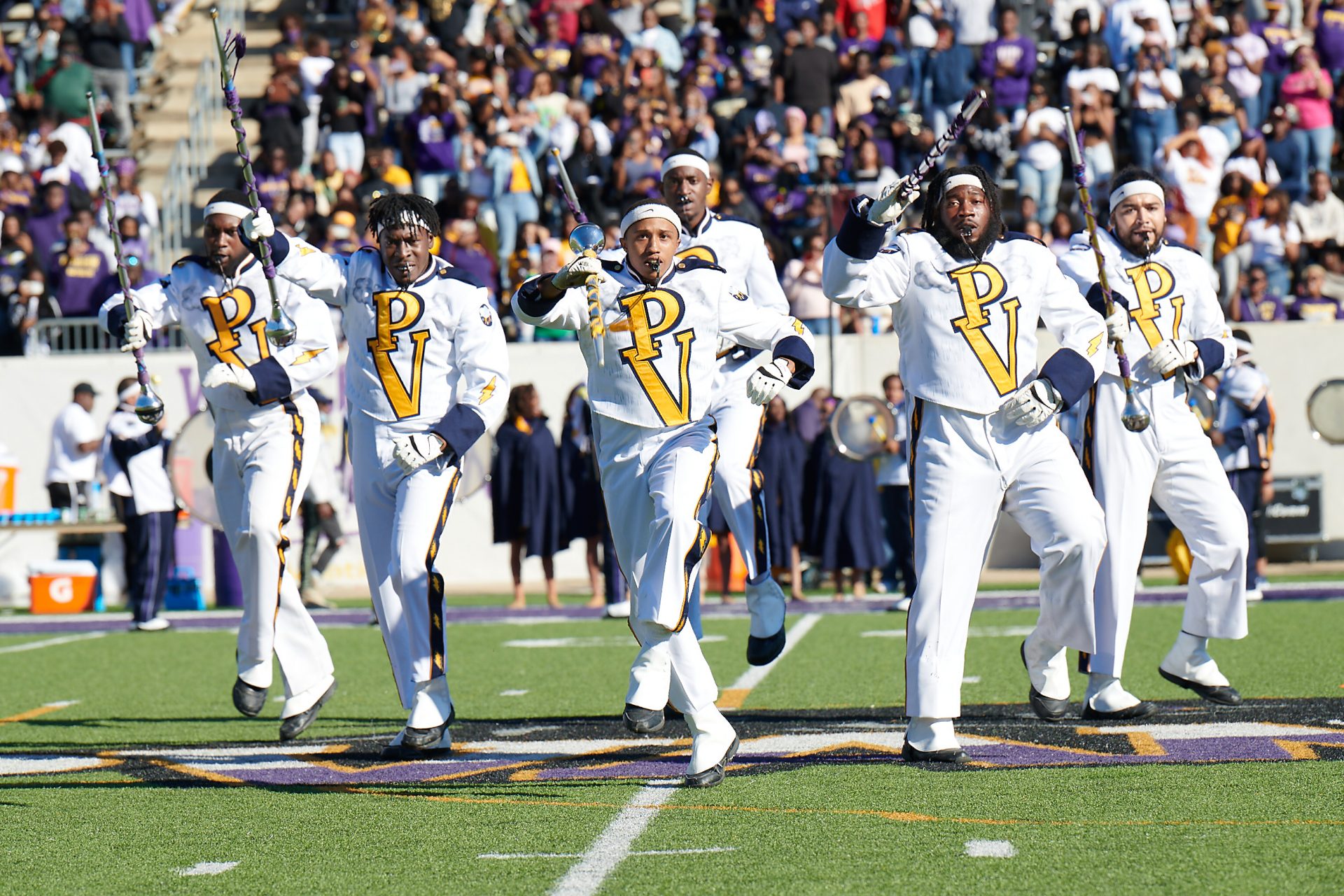 drum majors performing in college marching band PVAMU